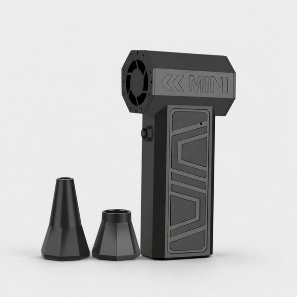 Black cordless turbo air duster with two nozzle attachments on a light gray studio background