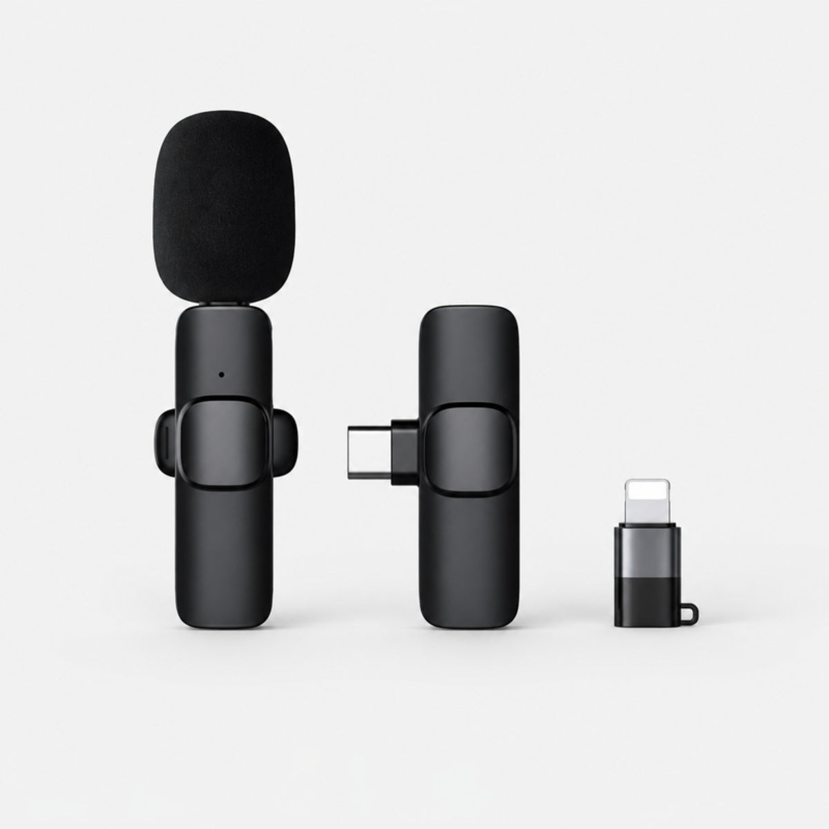 Black wireless lavalier clip-on microphone with USB-C receiver and Lightning adapter on a light gray studio background
